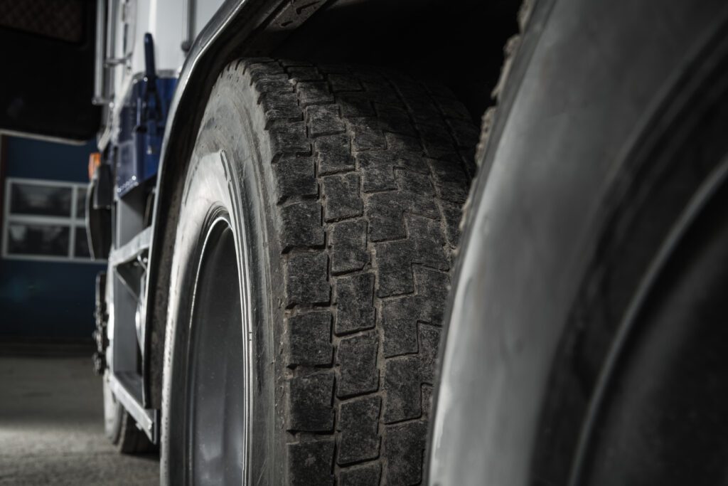 Close-up view of truck tires showing detailed tread pattern and sidewall, highlighting low rolling resistance for better fuel efficiency.
